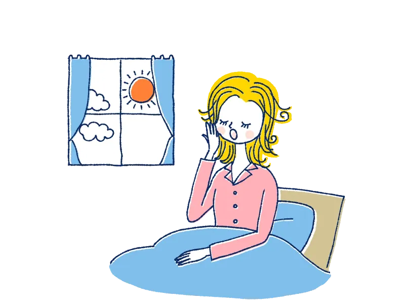 朝ベッドであくびをする女性
